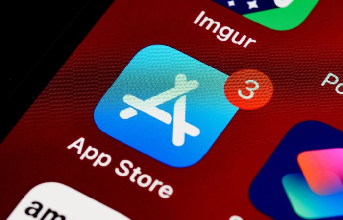 Close-up of App Store icon on iPhone screen with notification badge, highlighting app updates.