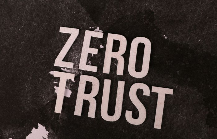 Bold 'Zero Trust' text against a textured black background, symbolizing cybersecurity.